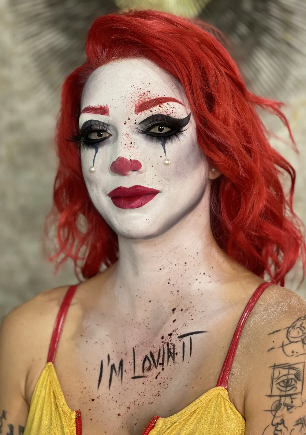 Red haired clown with graphic liner and blood detail