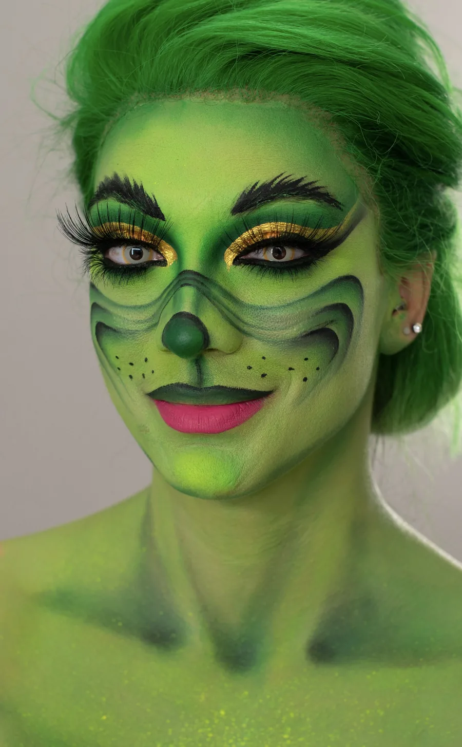 Full body green character makeup covering face, neck and chest