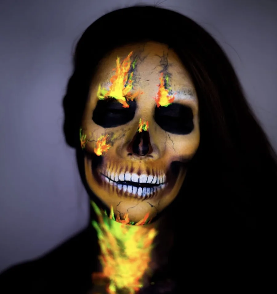 Glowing skull Halloween makeup across the whole face